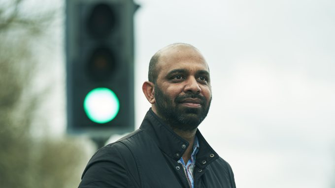 A man standing in front of a traffic light